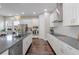 Modern kitchen with stainless steel appliances, dark hardwood floors, and white cabinets at 9085 Yonath St, Orlando, FL 32827