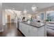Open concept kitchen with island seating and view into living area at 9085 Yonath St, Orlando, FL 32827