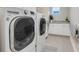Bright laundry room features granite countertops, white cabinets, and a large capacity washer and dryer at 9085 Yonath St, Orlando, FL 32827