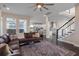 Open living room with a brown sectional sofa and dark hardwood floors at 9085 Yonath St, Orlando, FL 32827