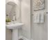 Elegant powder room with pedestal sink and stylish wall decor at 9085 Yonath St, Orlando, FL 32827