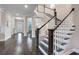 Grand staircase with dark wood and white railings at 9085 Yonath St, Orlando, FL 32827