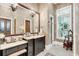 Elegant bathroom with dark vanity, marble countertop, and shower at 1120 Preserve Point Dr, Winter Park, FL 32789