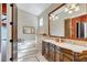 Bathroom with double vanity, soaking tub, and decorative wallpaper at 1120 Preserve Point Dr, Winter Park, FL 32789