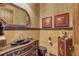 Upscale bathroom with black sink, gold fixtures, and decorative tile at 1120 Preserve Point Dr, Winter Park, FL 32789