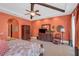 Bright bedroom with orange walls, dresser, and seating area at 1120 Preserve Point Dr, Winter Park, FL 32789