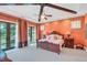 Bedroom with orange walls, king-size bed, and access to balcony at 1120 Preserve Point Dr, Winter Park, FL 32789