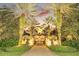 Elegant home at sunset, gated entrance, palm trees at 1120 Preserve Point Dr, Winter Park, FL 32789