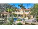 Backyard view of Mediterranean-style home with pool and lush landscaping at 1120 Preserve Point Dr, Winter Park, FL 32789