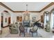 Elegant living room with fireplace, chandelier, and piano at 1120 Preserve Point Dr, Winter Park, FL 32789