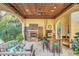 Outdoor kitchen with fireplace, bar seating, and built-in appliances at 1120 Preserve Point Dr, Winter Park, FL 32789