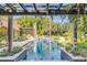 Stunning pool and patio with pergola and tropical landscaping at 1120 Preserve Point Dr, Winter Park, FL 32789