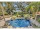 Resort-style pool and spa overlooking a lush, landscaped yard with lake views at 1120 Preserve Point Dr, Winter Park, FL 32789