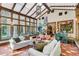 Spacious sunroom with comfortable seating and terracotta flooring at 1120 Preserve Point Dr, Winter Park, FL 32789