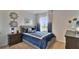 Cozy bedroom with blue and gray bedding at 1261 Limbali St, Mount Dora, FL 32757