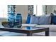 Glass-top coffee table with blue and white decorative vases at 1261 Limbali St, Mount Dora, FL 32757