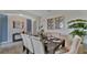 Elegant dining room with a dark wood table and neutral chairs at 1261 Limbali St, Mount Dora, FL 32757