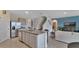Island kitchen with granite countertops and stainless steel appliances at 1261 Limbali St, Mount Dora, FL 32757