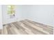 Small bedroom with laminate wood flooring and a window at 1834 E Orlando Rd, Orlando, FL 32820