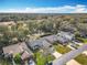 Overhead aerial view of the homes and surrounding landscape featuring beautiful trees and ponds in the distance at 2122 King Richards Ct, Orange City, FL 32763