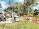 Well-manicured backyard with an outdoor kitchen, dining area, shed, landscaping, and grassy lawn at 2122 King Richards Ct, Orange City, FL 32763