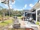 Comfortable backyard patio featuring an outdoor dining table and a relaxing swing at 2122 King Richards Ct, Orange City, FL 32763