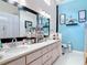 Bright bathroom showcasing double sinks, ample counter space, and tasteful blue accents at 2122 King Richards Ct, Orange City, FL 32763