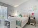 Charming bedroom with a wrought iron bed frame, soft lighting, and stylish decor at 2122 King Richards Ct, Orange City, FL 32763