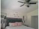 Bedroom with a ceiling fan, large bed, bedside lamps, and stylish wall decor at 2122 King Richards Ct, Orange City, FL 32763