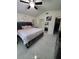 Bright bedroom featuring a large bed, stylish decor, and access to en-suite bathroom at 2122 King Richards Ct, Orange City, FL 32763
