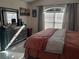 Bright bedroom with a queen bed and ample dresser space at 2122 King Richards Ct, Orange City, FL 32763