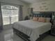 Comfortable bedroom with ample natural light, a decorative headboard, and sleek tile flooring at 2122 King Richards Ct, Orange City, FL 32763