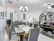 Open-concept dining room with glass table, modern chairs, and stylish decor at 2122 King Richards Ct, Orange City, FL 32763