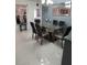Elegant dining room with glass table, six chairs, and a stylish buffet cabinet at 2122 King Richards Ct, Orange City, FL 32763
