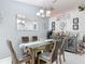 Chic dining room with modern chandelier, wet bar, and stylish furnishings at 2122 King Richards Ct, Orange City, FL 32763