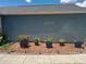 Exterior of home showcasing flower bed in front of the home with mulch at 2122 King Richards Ct, Orange City, FL 32763