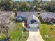 Inviting front exterior featuring a well-kept lawn, landscaped flower beds, and a two-car garage at 2122 King Richards Ct, Orange City, FL 32763