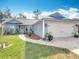 Charming single-story home with a well-manicured lawn and attached two car garage in a quiet neighborhood at 2122 King Richards Ct, Orange City, FL 32763