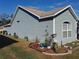 Side view of a light blue house with landscaping at 2122 King Richards Ct, Orange City, FL 32763
