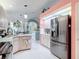Bright kitchen features stainless steel refrigerator, island and updated cabinets at 2122 King Richards Ct, Orange City, FL 32763