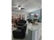 Open-concept living space with dining area, ceiling fan, and natural light at 2122 King Richards Ct, Orange City, FL 32763