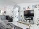 Inviting living room featuring beach decor, tv, leather furniture and white floors at 2122 King Richards Ct, Orange City, FL 32763