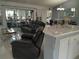 Spacious living area flowing into the dining area, featuring a comfortable recliner and stylish decor at 2122 King Richards Ct, Orange City, FL 32763