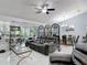 Spacious living room with sliding glass doors to the lanai and dining room at 2122 King Richards Ct, Orange City, FL 32763