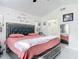 Elegant bedroom features a large bed with a tufted headboard and soft, inviting pink bedding at 2122 King Richards Ct, Orange City, FL 32763