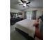 Bright main bedroom with a large window, dresser, and ceiling fan at 2122 King Richards Ct, Orange City, FL 32763
