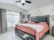 Vaulted ceiling bedroom with large bed, gray curtains, and ceiling fan at 2122 King Richards Ct, Orange City, FL 32763