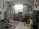 Home office with a desk, chair, and exercise equipment at 2122 King Richards Ct, Orange City, FL 32763