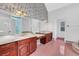 Elegant bathroom with dual vanities, a large mirror, and a pink tile floor at 2229 Earleaf Ct, Longwood, FL 32779