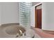 Spa-like bathroom with a large soaking tub, glass block window, and shower at 2229 Earleaf Ct, Longwood, FL 32779